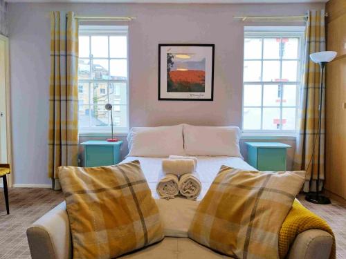 a bedroom with a bed with two pillows on it at amazing apartments - Websters Land - Castle View in Edinburgh