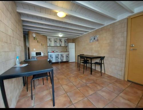 a large room with two tables and a kitchen at MasRelaxTenerife in La Laguna