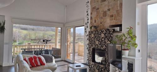 a living room with a couch and a fireplace at Villa Flavina in San Vicente del Valle