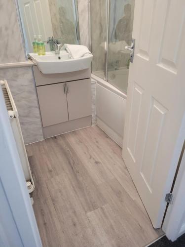 a bathroom with a sink and a shower at RentUnique Nimrod House 2 bed ample parking in Crawley