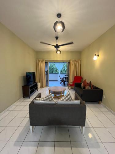 a living room with a couch and a table at The Oxford Suite in Bentong