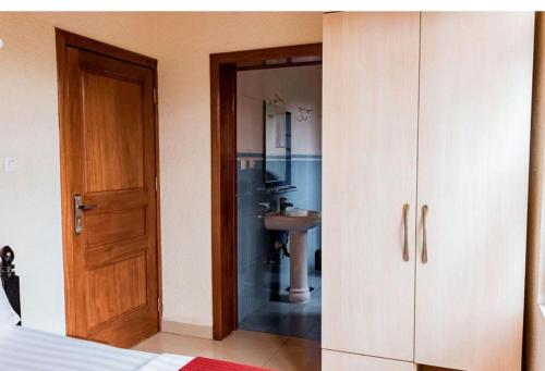 吉佳利的住宿－NYUMBANI CITY CENTER ACCOMODATION，一间卧室,配有带水槽和橱柜的浴室