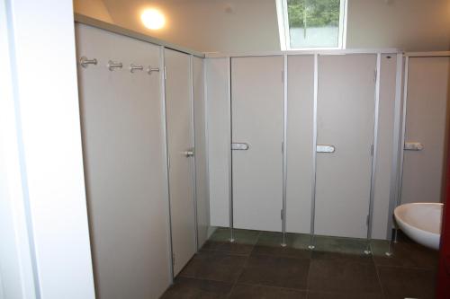 baño con armarios blancos y lavamanos en Paschen Monteurzimmer, 