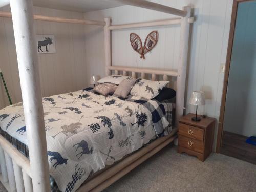 a bedroom with a bed with a wooden frame at Mountain Hideaway in Crouch