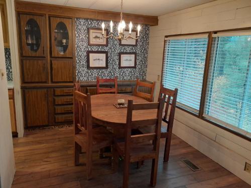 a dining room with a wooden table and chairs at Mountain Hideaway in Crouch