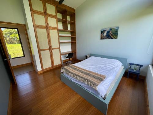 a bedroom with a bed and a book shelf at Aires de Quetzales in Concepción