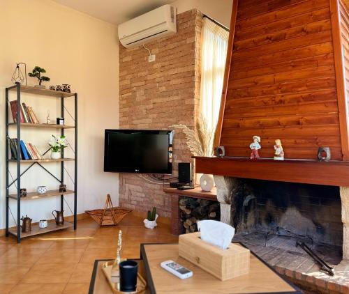 a living room with a fireplace and a tv at SkyView Oasis Premium Apartment in Tirana