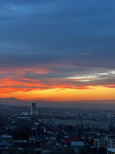 a view of a city at sunset at Дом с потрясающим видом in Almaty