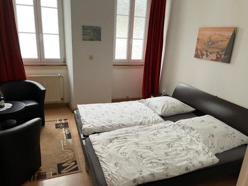 a living room with two beds and a couch at Holländers Apartment in Bruchsal