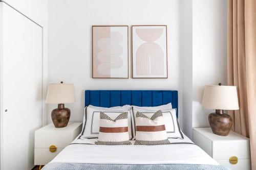 a bedroom with a blue and white bed with two lamps at 91-1D 3BR 2baths Duplex with a Private Back yard - GYM in New York