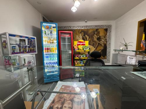 a person sitting at a counter in a soda shop at HOTEL SAN ANTONIO PLAZA in Cali