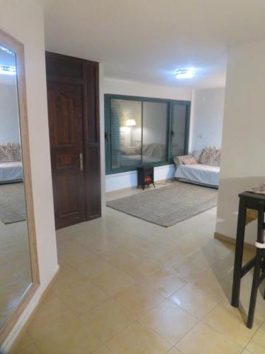 a living room with a couch and a table at Self-Contained Garden apartment with Galilee sea & mountains view 2 in Safed