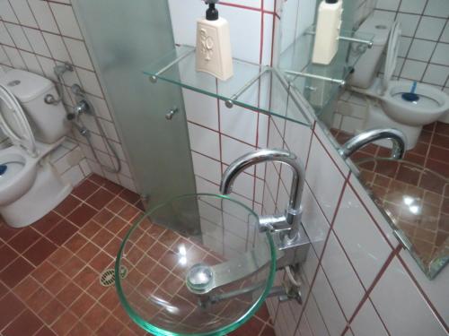 a bathroom with a sink and a toilet and a mirror at Self-Contained Garden apartment with Galilee sea & mountains view 2 in Safed