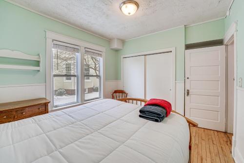 a bedroom with a large white bed and a window at Ludington Home with 6 Bicycles Less Than 1 Mi to Beach! in Ludington