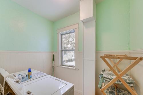a laundry room with a sink and a window at Ludington Home with 6 Bicycles Less Than 1 Mi to Beach! in Ludington