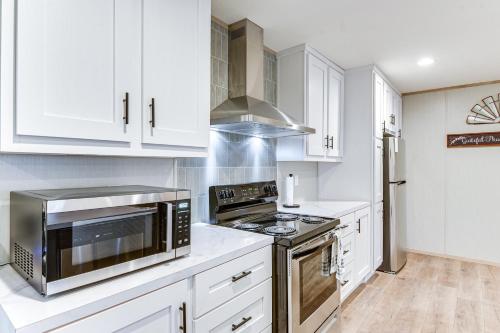 a kitchen with white cabinets and stainless steel appliances at Hudson Oaks Country Creekside Home Hot Tub and Deck in Weatherford