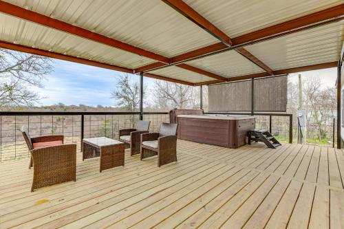 a covered deck with chairs and a table and a grill at Hudson Oaks Country Creekside Home Hot Tub and Deck in Weatherford