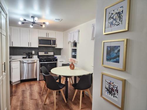 a kitchen with a table and chairs in a room at Chic Spacious Apt Near Attractions/Food/EWR/NYC in West Orange