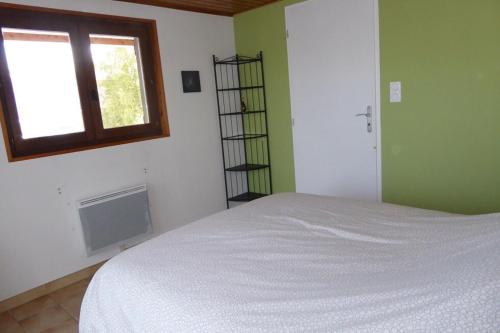 a bedroom with a white bed and a window at Chalet avec grand jardin en Chartreuse Alpes in Miribel-les-Échelles
