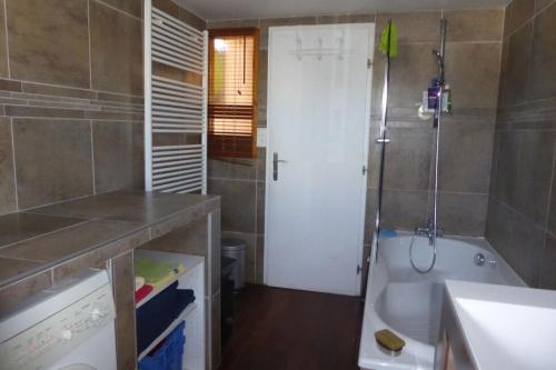 a bathroom with a tub and a shower and a sink at Chalet avec grand jardin en Chartreuse Alpes in Miribel-les-Échelles