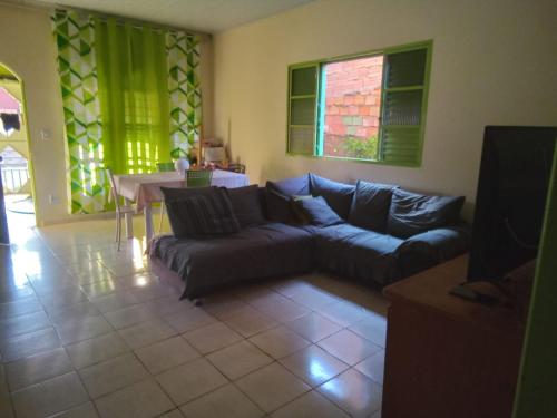 a living room with a couch and a table at CASA MJ HOSPEDAGEM in Porto Velho