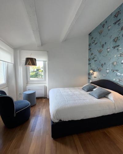 a bedroom with a large bed and a blue wall at About Italy Holiday Rooms and Apartments in Portovenere