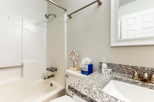 a white bathroom with a sink and a bath tub at Hilton Head Resort 4336 in Hilton Head Island