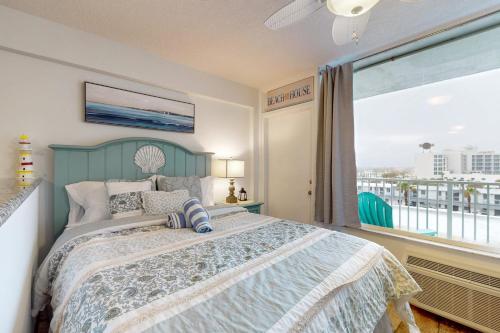 a bedroom with a bed and a large window at Daytona Beach Club Unit 523 in Daytona Beach