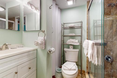 a bathroom with a toilet and a glass shower at Daytona Beach Club Unit 523 in Daytona Beach