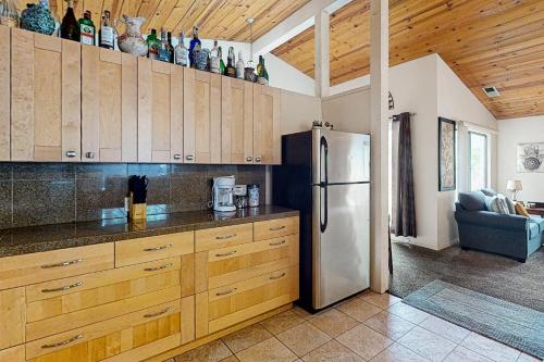 a kitchen with wooden cabinets and a refrigerator at Momma's Paradise in Three Rivers