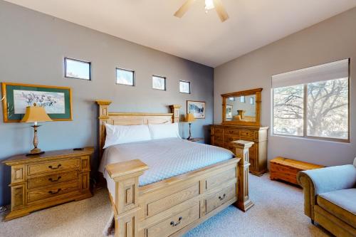 a bedroom with a bed and a chair and a window at The Fox Den in Tucson