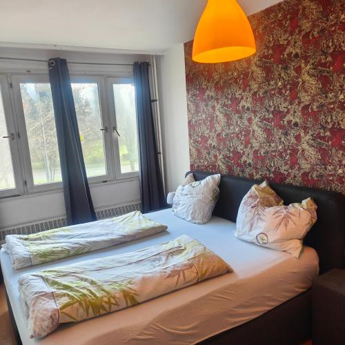 a bed with two pillows on it in a bedroom at MO HOME24 in Cologne