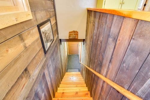 a hallway with wooden walls and wooden stairs at Cozy Ouray Hideaway Mountain Views, Steps to Main in Ouray