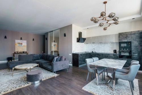 a living room with a couch and a table at Odesa Pearl Apartments in Odesa