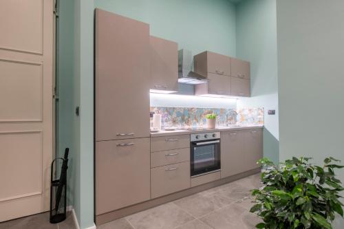 a kitchen with white cabinets and a stove at 227 - Largo Zecca Luxury Apartment - Nel cuore del centro di Genova in Genova