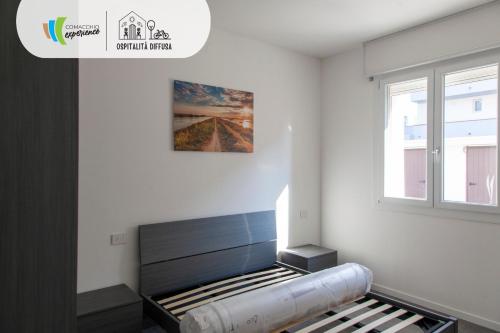 リド・ディ・ポンポーザにあるComacchio Experience - Ospitalità Diffusaのベッド付きの部屋