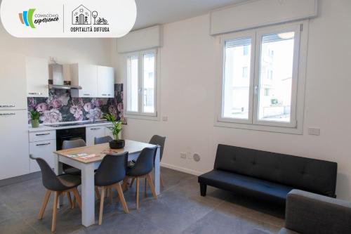 a kitchen and dining room with a table and chairs at Comacchio Experience - Ospitalità Diffusa in Lido di Pomposa
