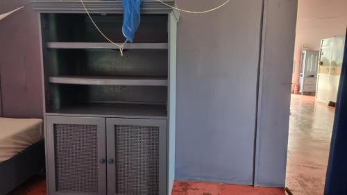 a room with a closet with a book shelf at Il Triangolo Hostel in Las Galeras