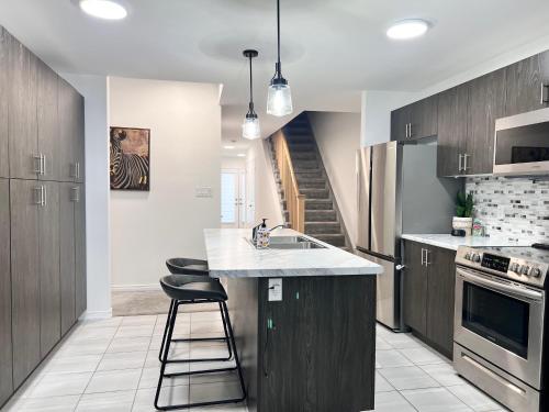 a kitchen with a sink and a counter top at Spacious 4-Bedroom Home, Comfortably Sleeps 10 in Barrie