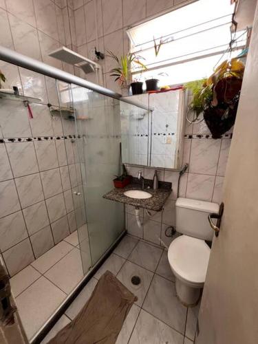 a bathroom with a shower and a toilet and a sink at Vem curtir na praia e na cidade. in Salvador
