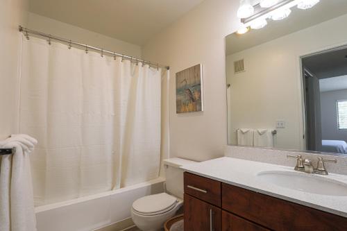 a bathroom with a sink and a toilet and a mirror at Oceanside Beach style King & 2 queen beds in Oceanside