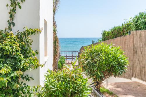 a house with a view of the ocean at Cozy beachfront 2BR with Terrace, Pool and Garage in Sitio de Calahonda