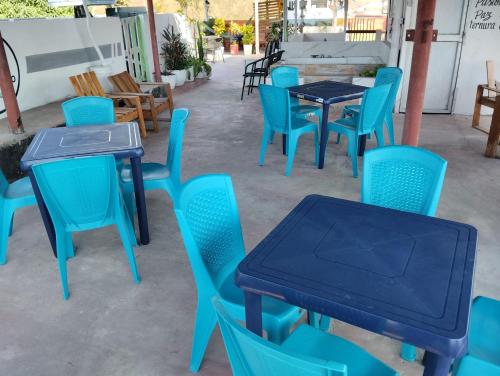a group of blue tables and chairs in a patio at Del Castillo Mirador Hostel in Cartagena de Indias