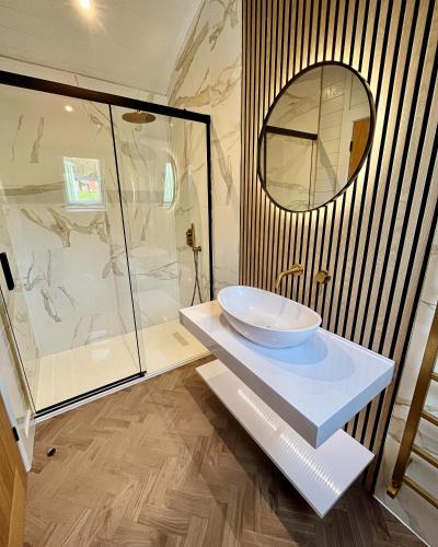 a bathroom with a sink and a glass shower at Mingarry Park in Acharacle
