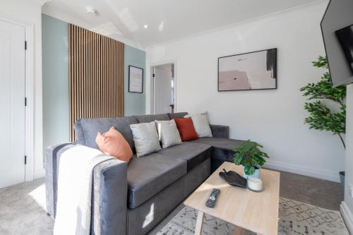 a living room with a couch and a coffee table at Elland Retreat By NordStay in Beeston Hill