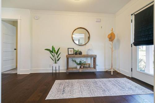 a living room with a mirror and a table at King Suite Highland House of Historic Franklin in Franklin
