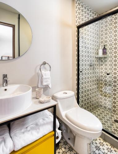 a bathroom with a toilet and a sink and a shower at VICENTE SUAREZ By Mr W in Mexico City