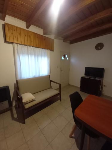- un salon avec un canapé et une fenêtre dans l'établissement Duplex Alvear 112, à Venado Tuerto
