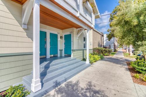 a house with blue doors and a sidewalk at East Village Apartments in Long Beach
