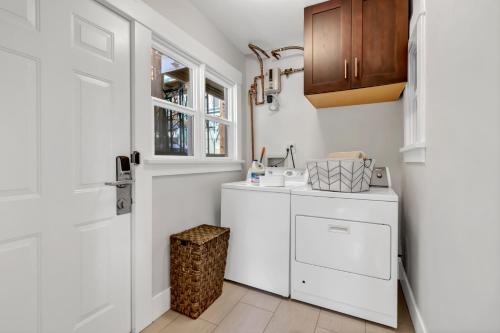 a white kitchen with a counter and a door at East Village Apartments in Long Beach